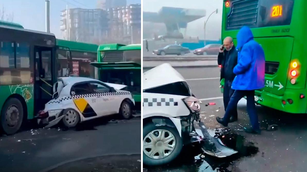 Geely расплющило между двумя автобусами в Алматы
