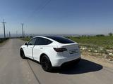 Tesla Model Y 2024 года за 19 800 000 тг. в Алматы – фото 5